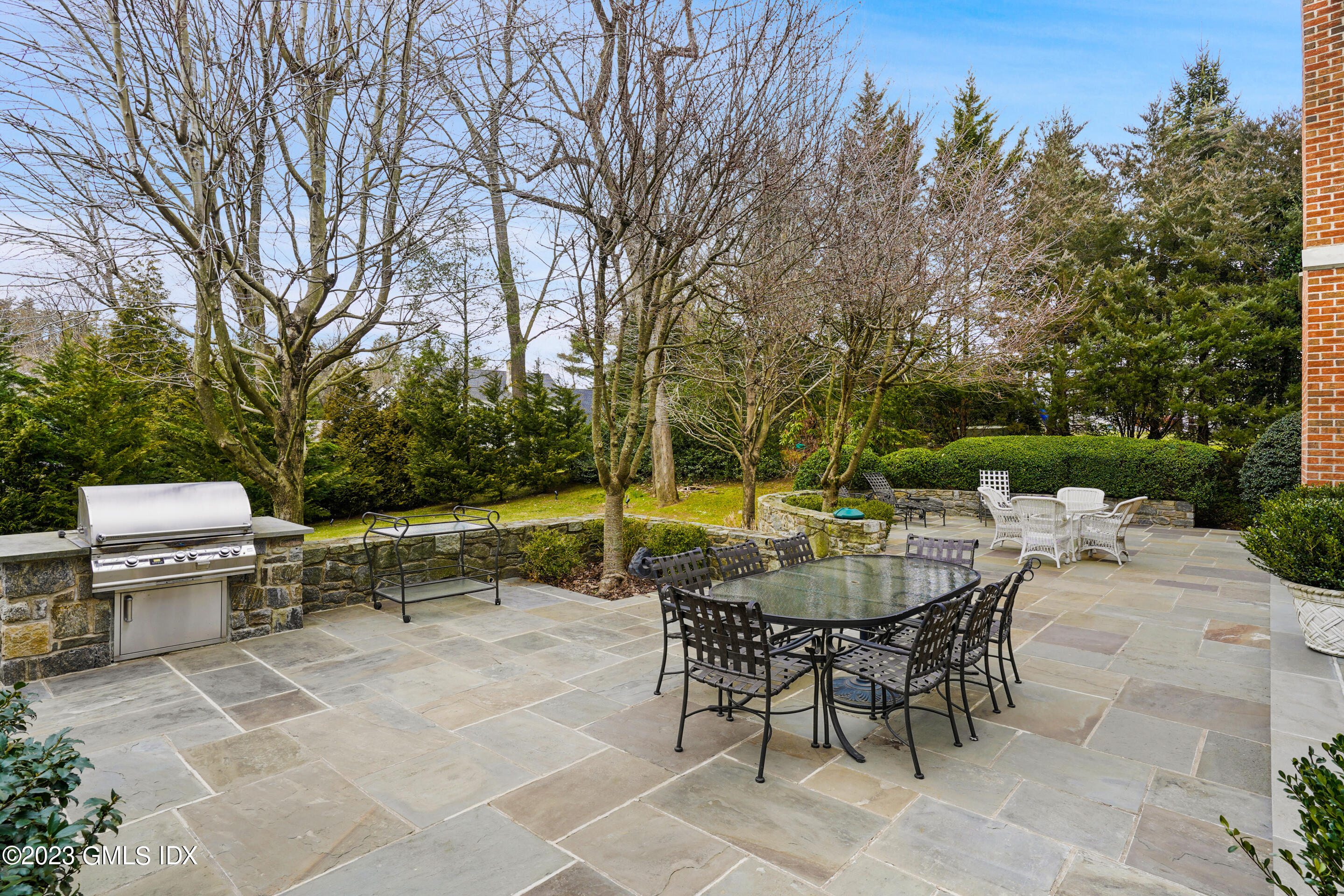 55 North Street Greenwich, CT 06830 - Photo 38 of 44 a view of a patio with a dining table and chairs with a fire pit