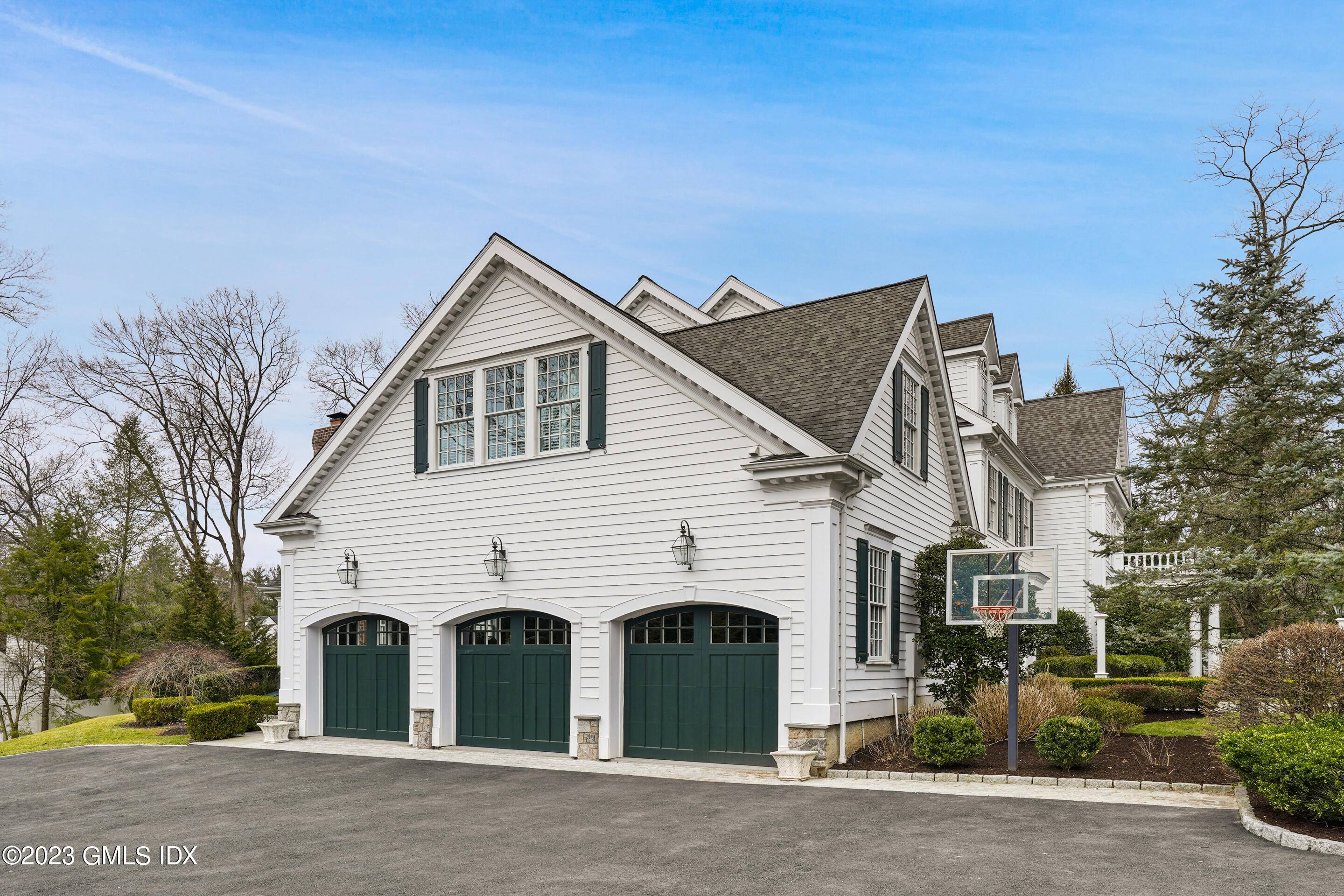 55 North Street Greenwich, CT 06830 - Photo 40 of 44 a view of a white house next to a road and yard
