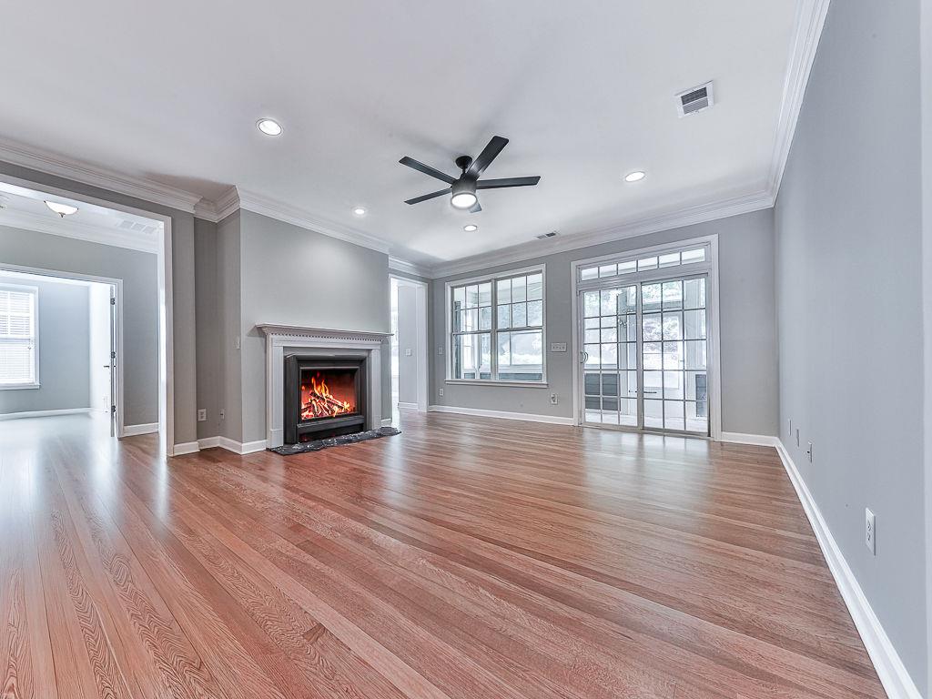 626 Laurel Crossing Canton, GA 30114 - Photo 15 of 77 wooden floor fireplace and windows in an empty room