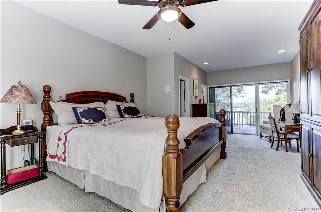 31001 Executive Point Tega Cay, SC 29708 - Photo 11 of 24 a bedroom with a bed a table and chairs