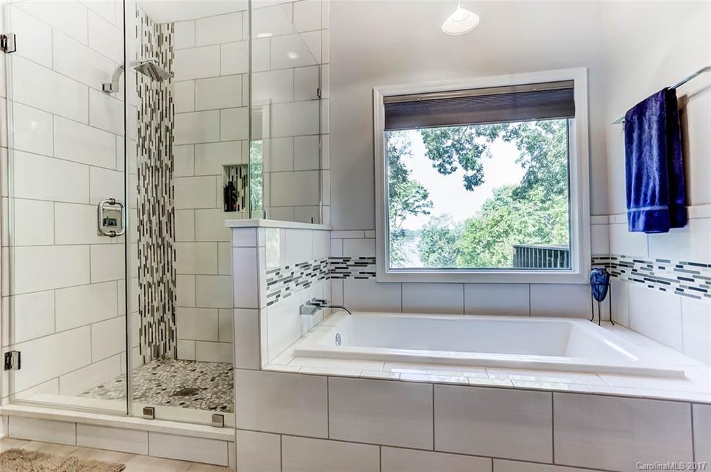31001 Executive Point Tega Cay, SC 29708 - Photo 14 of 24 a bathroom with a bathtub and window