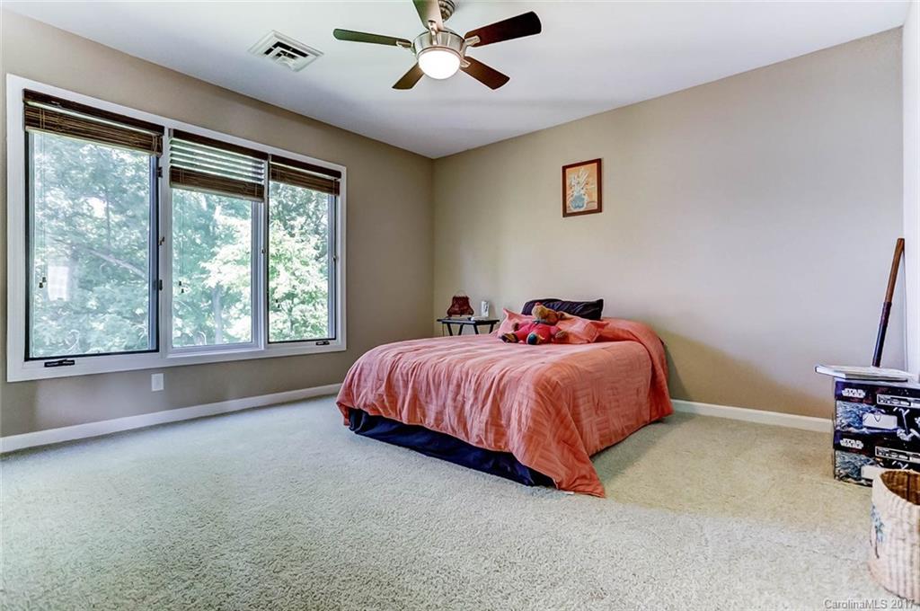 31001 Executive Point Tega Cay, SC 29708 - Photo 15 of 24 a bed sitting in a spacious bedroom next to a window