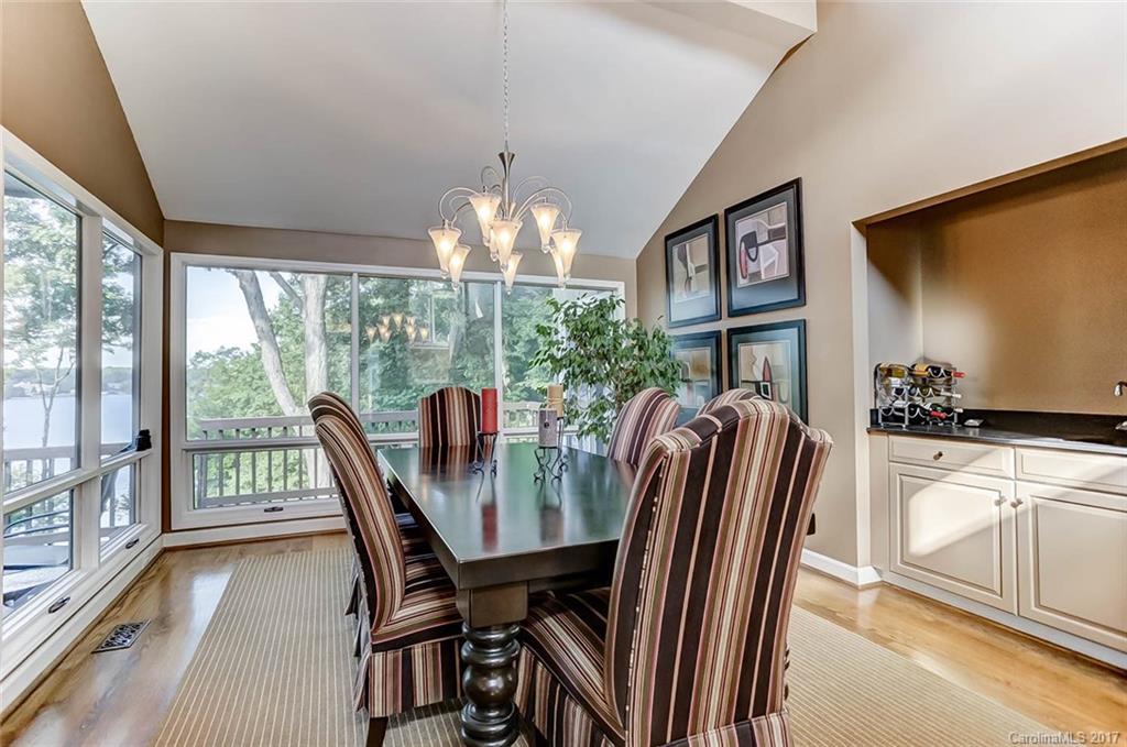31001 Executive Point Tega Cay, SC 29708 - Photo 6 of 24 a view of a dining room with furniture a chandelier and large windows