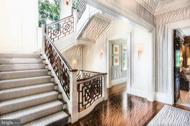 a view of entryway and hall with wooden floor