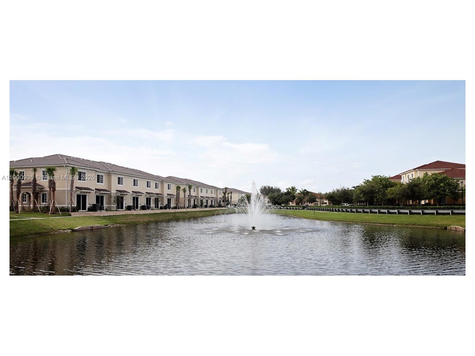 2714 Southwest 81st Terrace, Unit 2718 Miramar, FL 33025 - Photo 7 of 12 a view of a lake with houses in the background