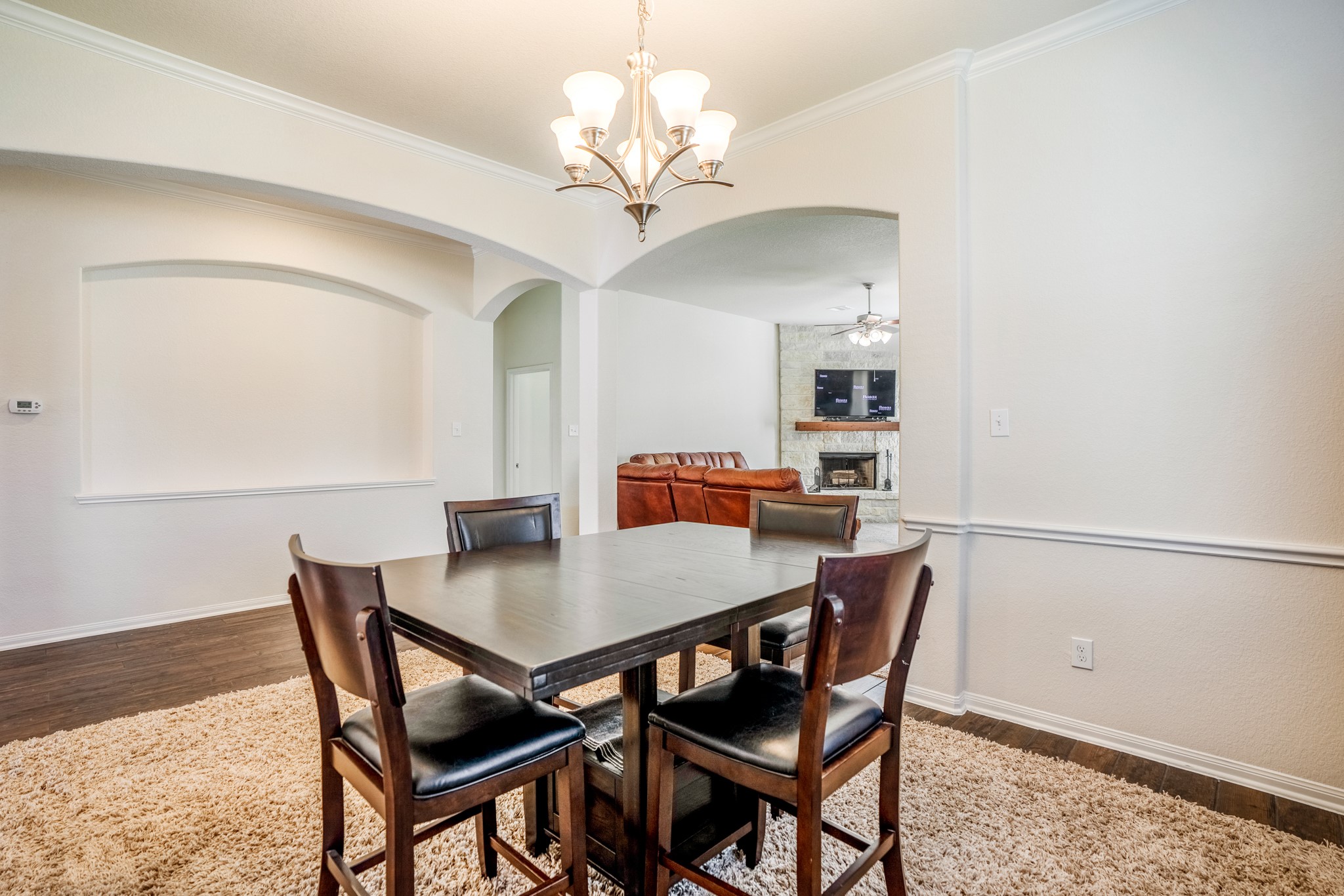 1730 Wandering Hills Road Conroe, TX 77304 - Photo 15 of 45 a view of a dining room with furniture and chandelier