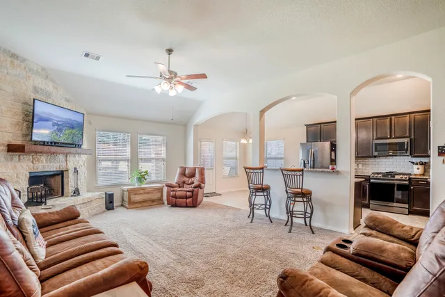 a living room with furniture and fireplace