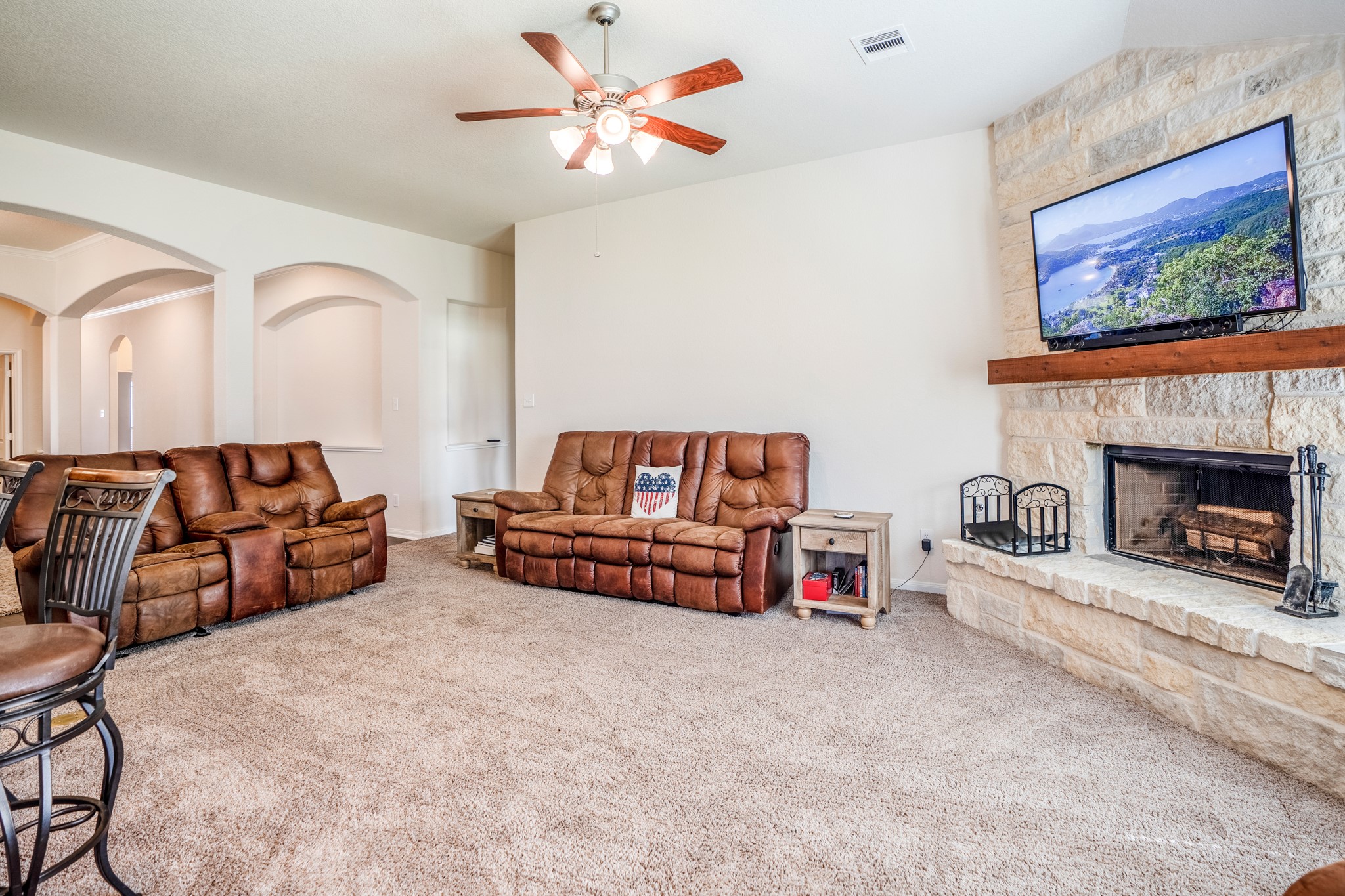 1730 Wandering Hills Road Conroe, TX 77304 - Photo 20 of 45 a living room with furniture a flat screen tv and a fireplace