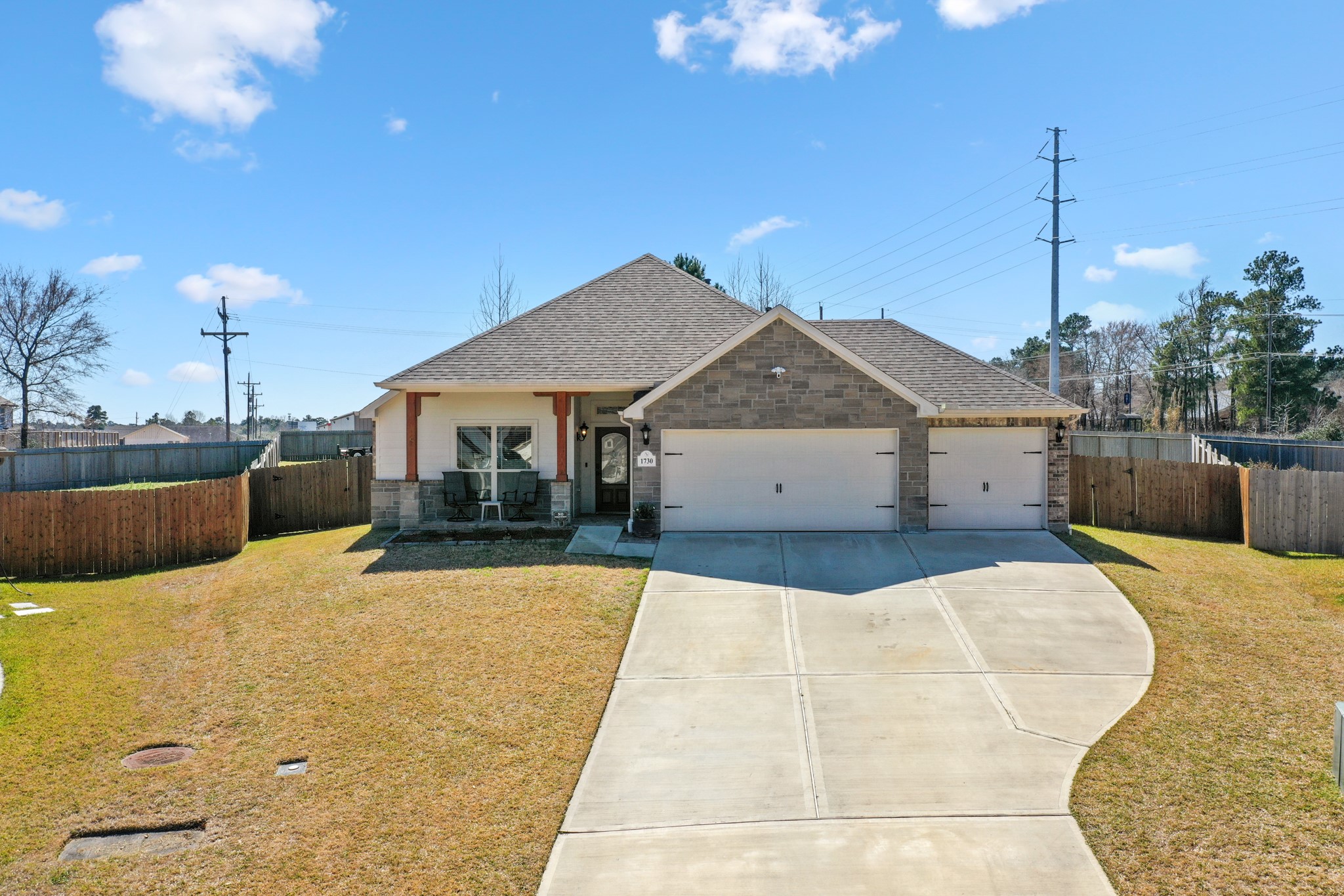 1730 Wandering Hills Road Conroe, TX 77304 - Photo 2 of 45 a front view of a house with a yard