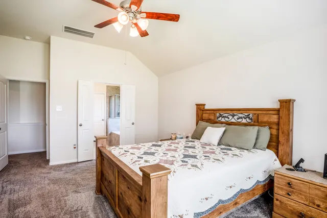 a bathroom with a granite countertop bathtub sink vanity and mirror