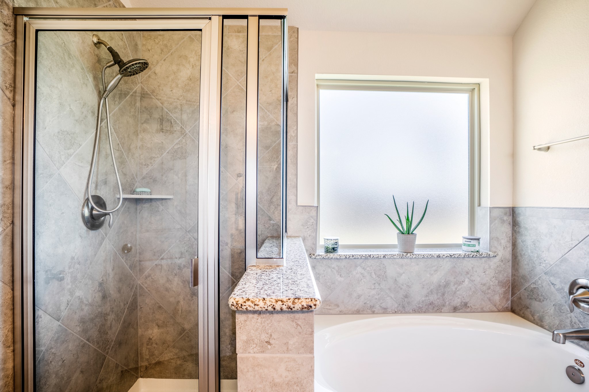 1730 Wandering Hills Road Conroe, TX 77304 - Photo 29 of 45 a bathroom with a granite countertop bathtub and shower