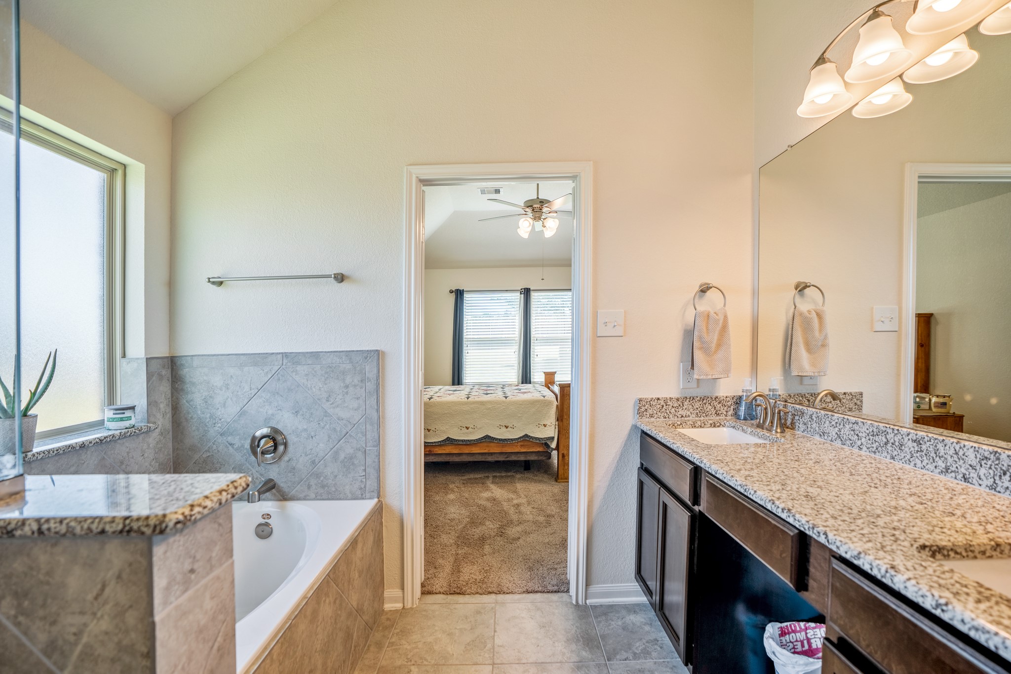 1730 Wandering Hills Road Conroe, TX 77304 - Photo 30 of 45 a en suite bathroom with a granite countertop tub sink and mirror