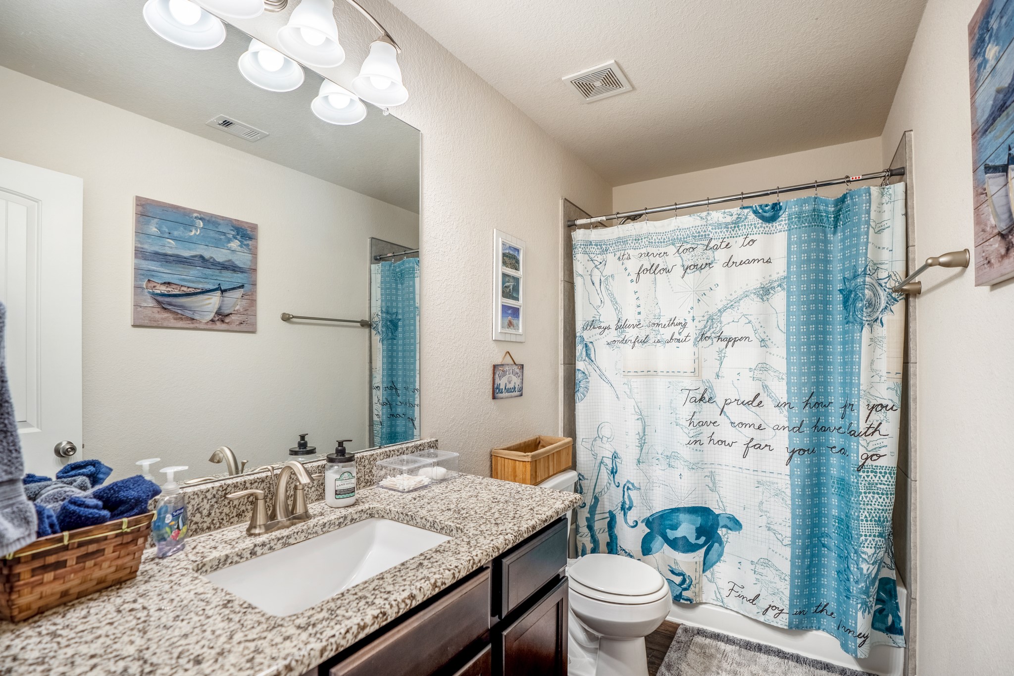 1730 Wandering Hills Road Conroe, TX 77304 - Photo 3 of 45 a bathroom with a granite countertop sink a toilet and a mirror