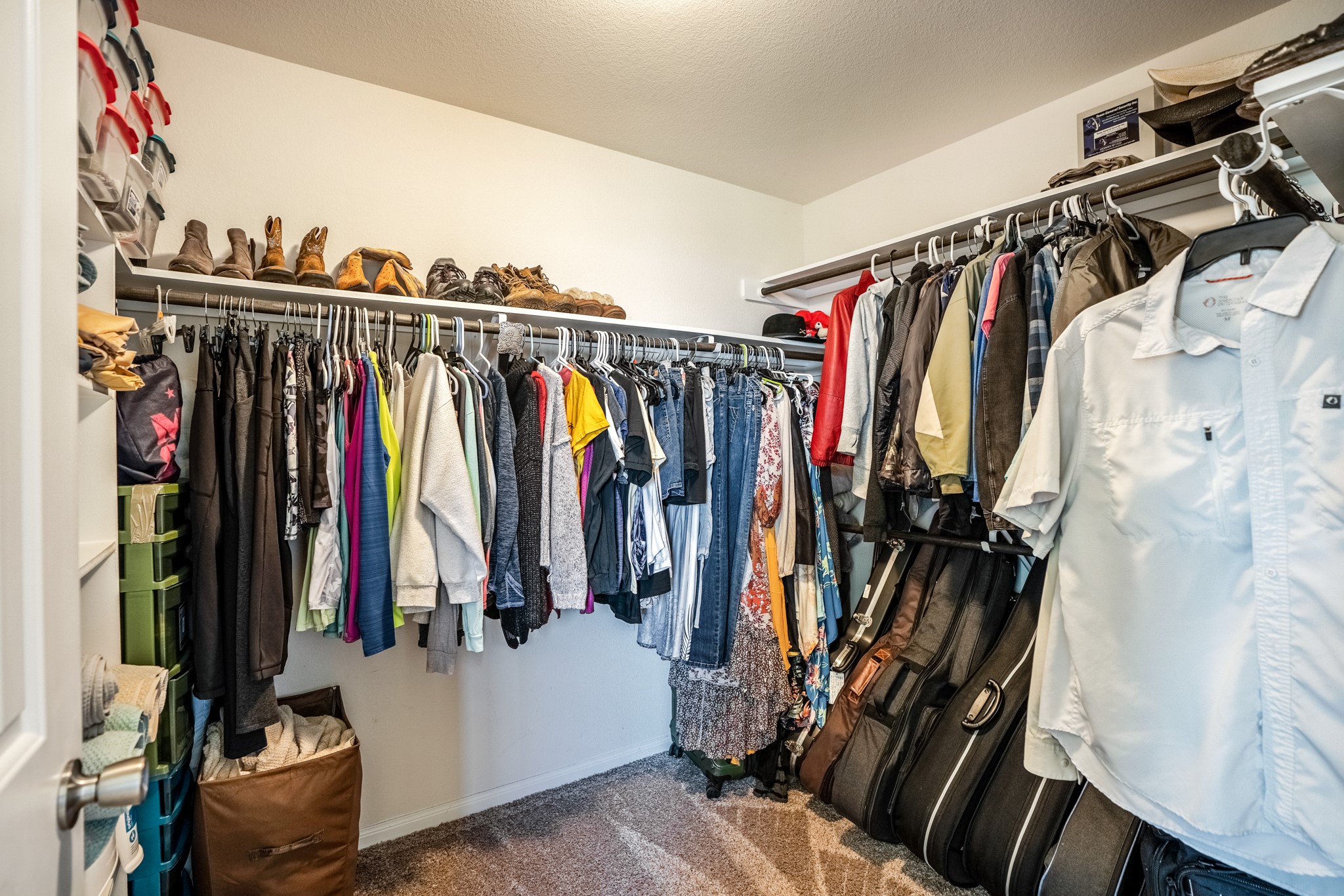1730 Wandering Hills Road Conroe, TX 77304 - Photo 31 of 45 a view of walk in closet with clothes and shoes