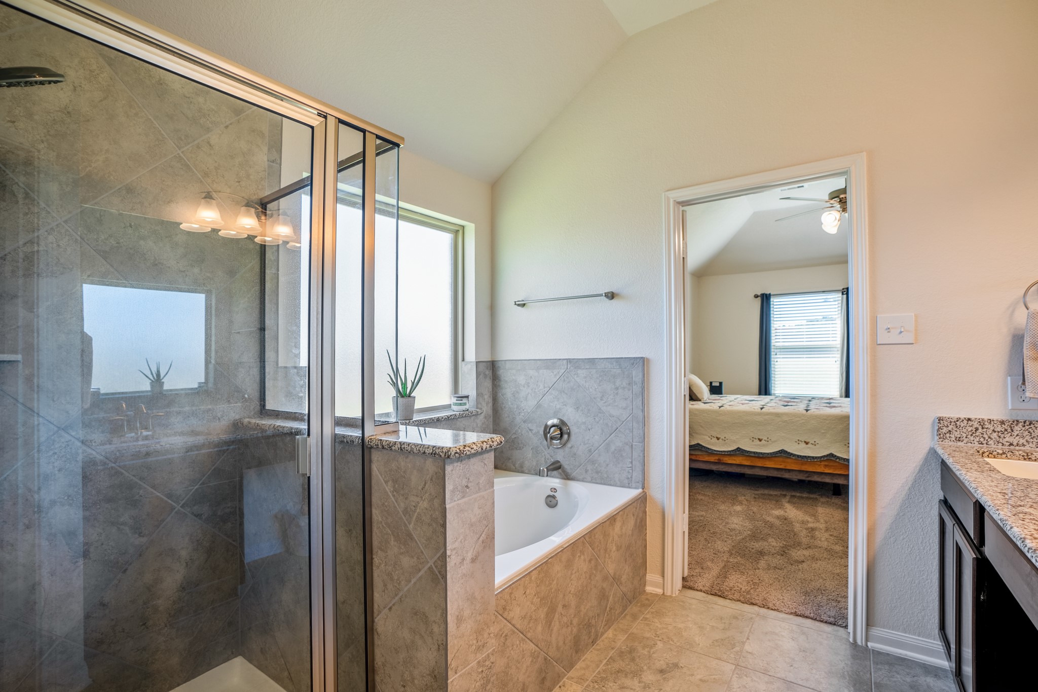 1730 Wandering Hills Road Conroe, TX 77304 - Photo 32 of 45 a en suite bathroom with a tub sink and mirror