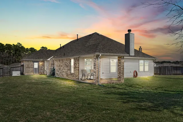 a backyard of a house with table and chairs