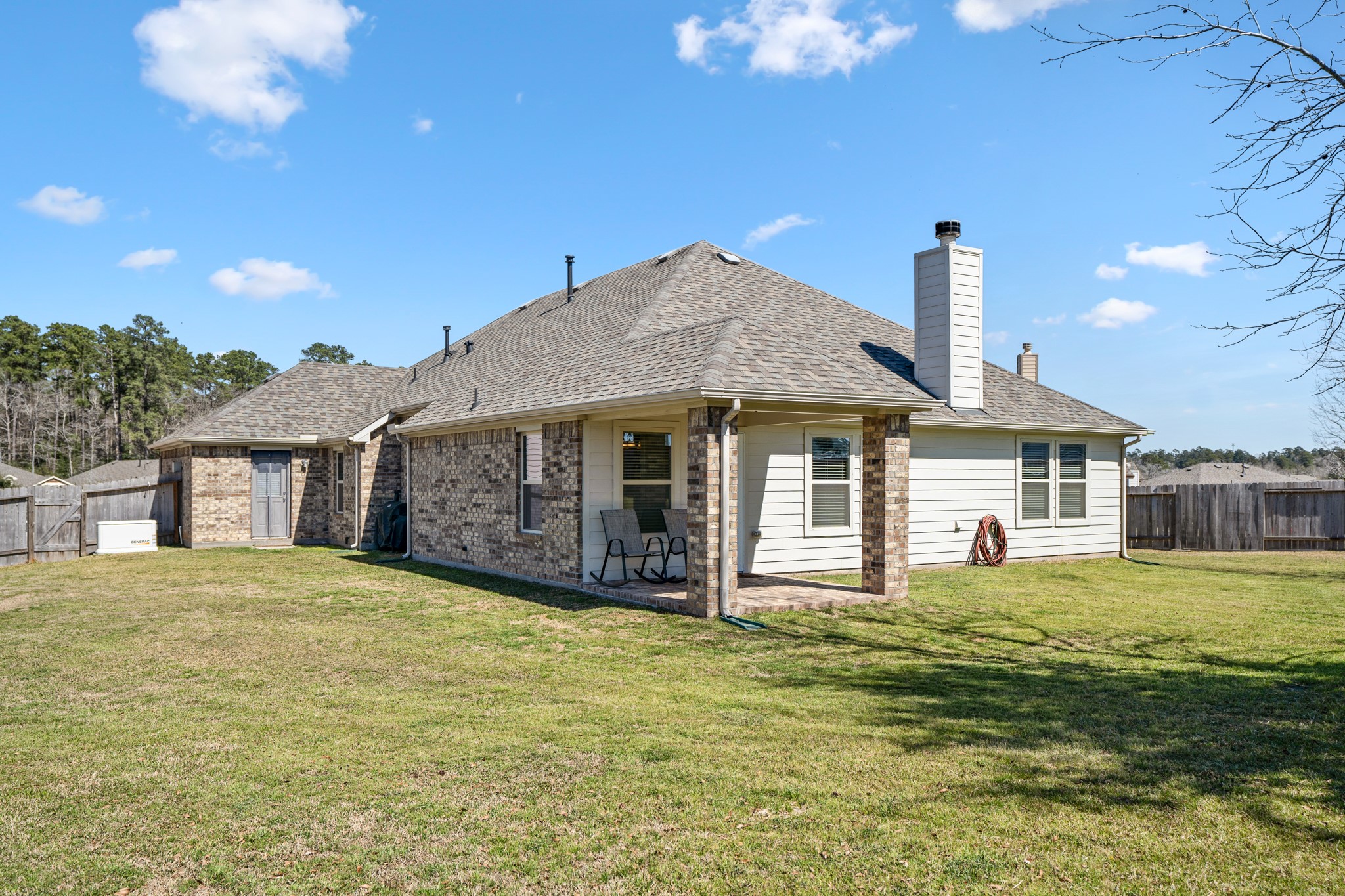 1730 Wandering Hills Road Conroe, TX 77304 - Photo 39 of 45 a front view of a house with a yard