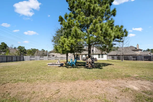 a view of a yard with wooden fence