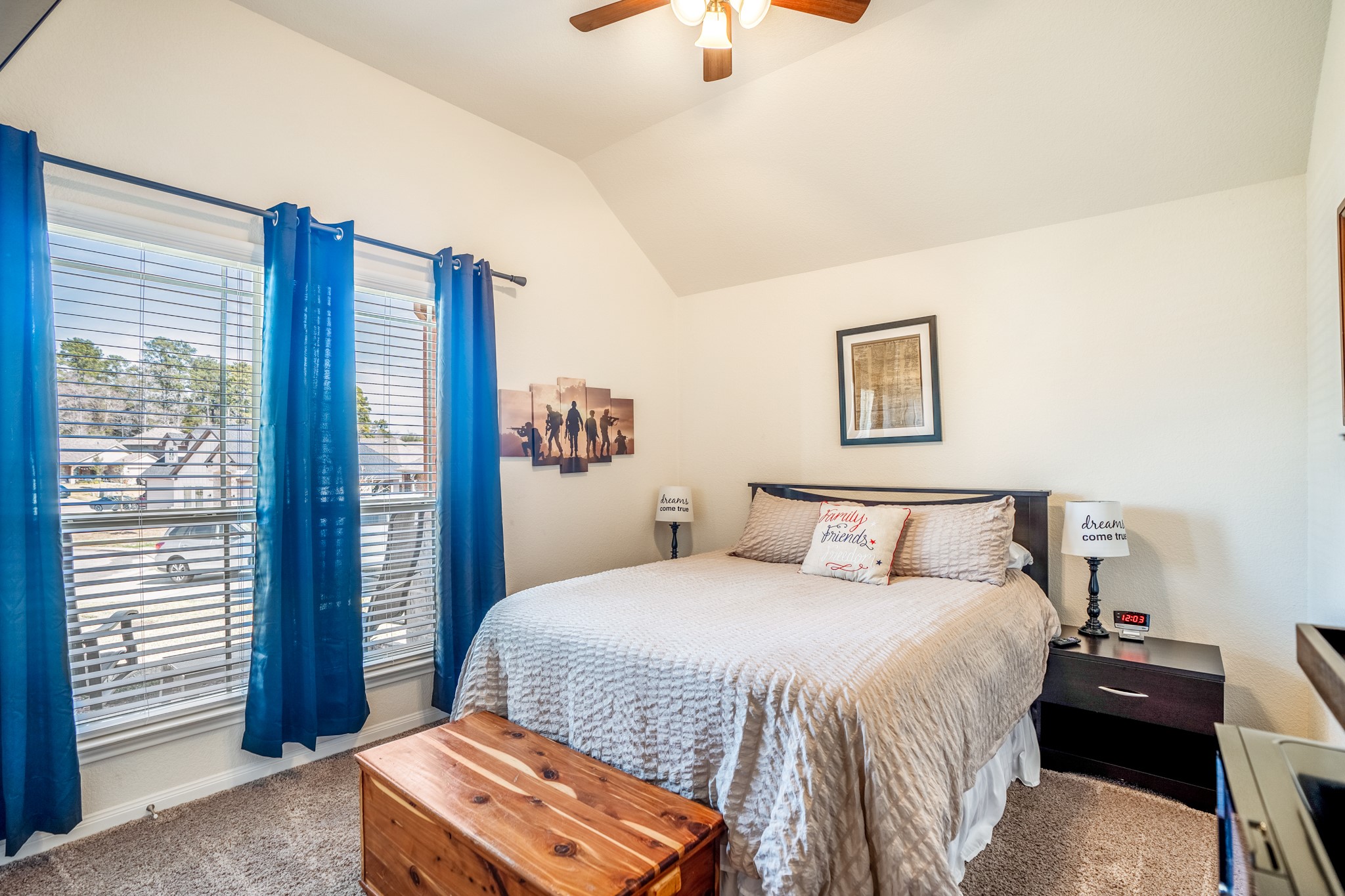 1730 Wandering Hills Road Conroe, TX 77304 - Photo 4 of 45 a bedroom with a bed and a chandelier