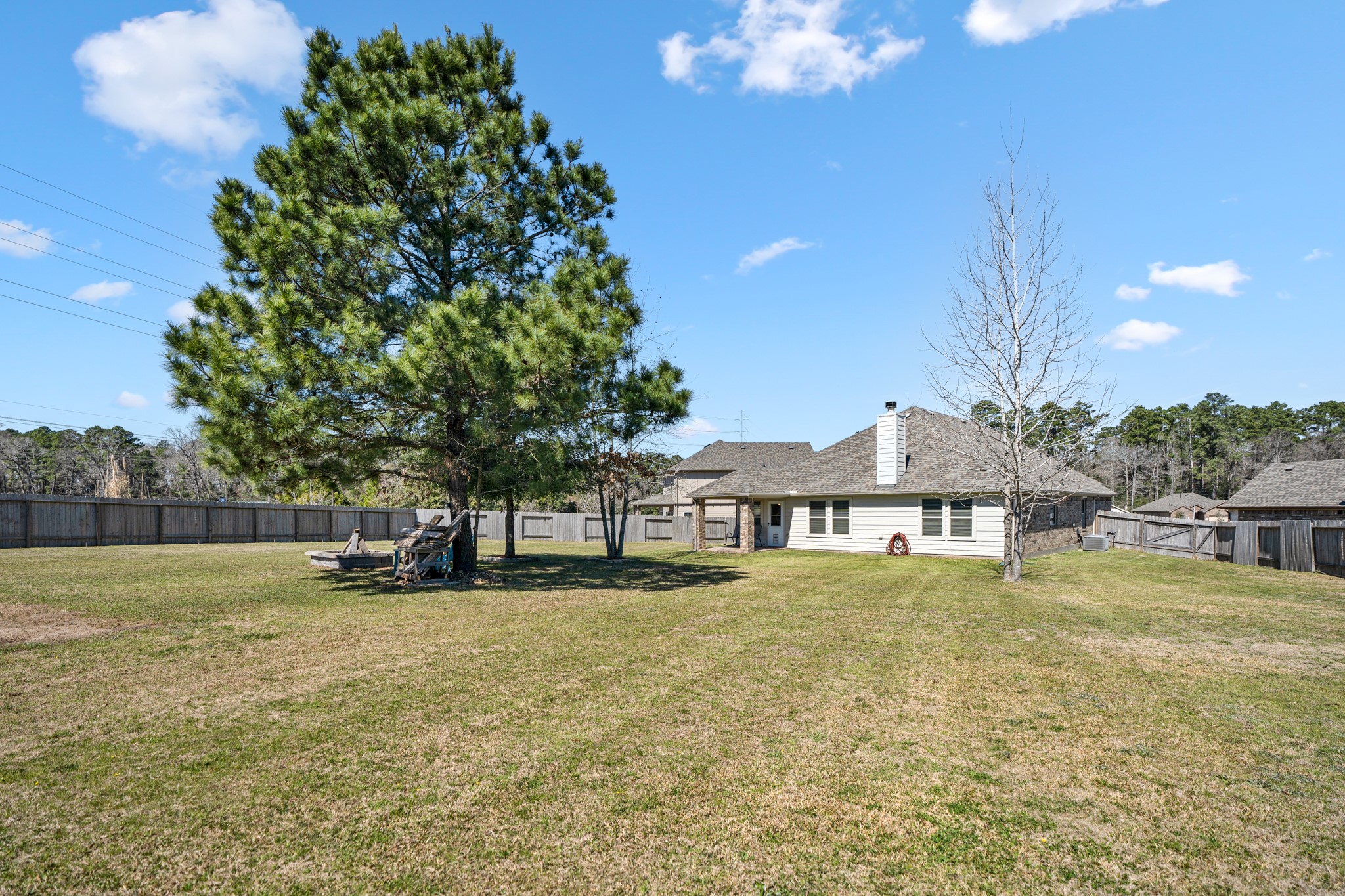 1730 Wandering Hills Road Conroe, TX 77304 - Photo 41 of 45 a view of a house with swimming pool and a yard