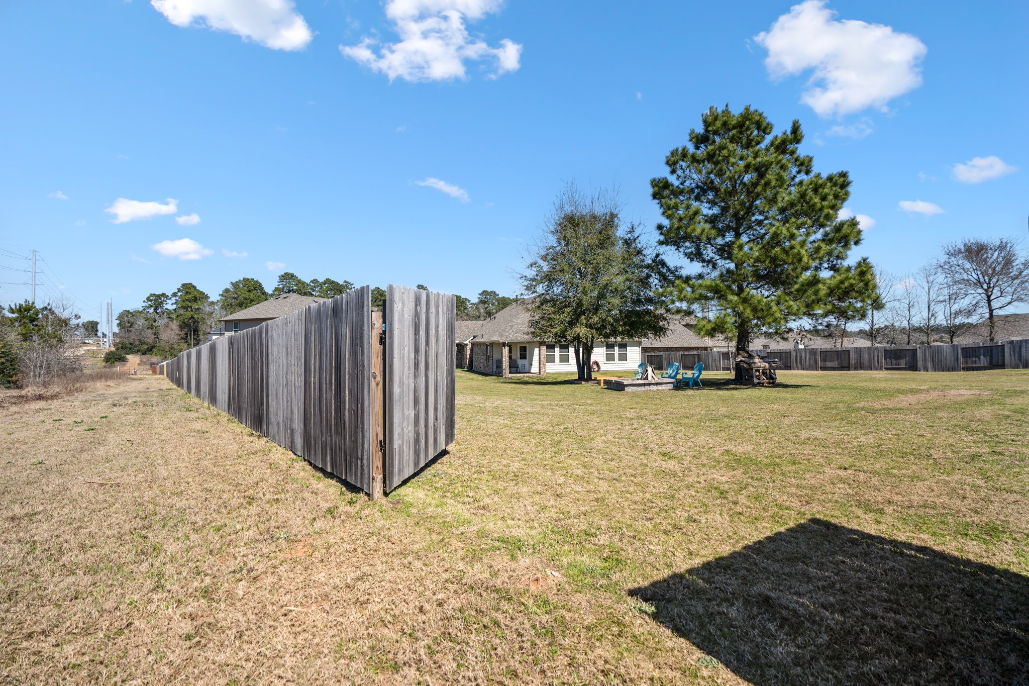 1730 Wandering Hills Road Conroe, TX 77304 - Photo 42 of 45 a view of a yard with wooden fence