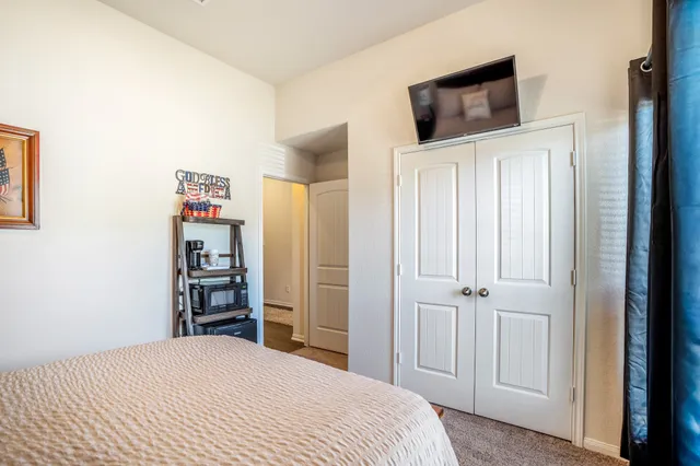 a bedroom with a bed and a television