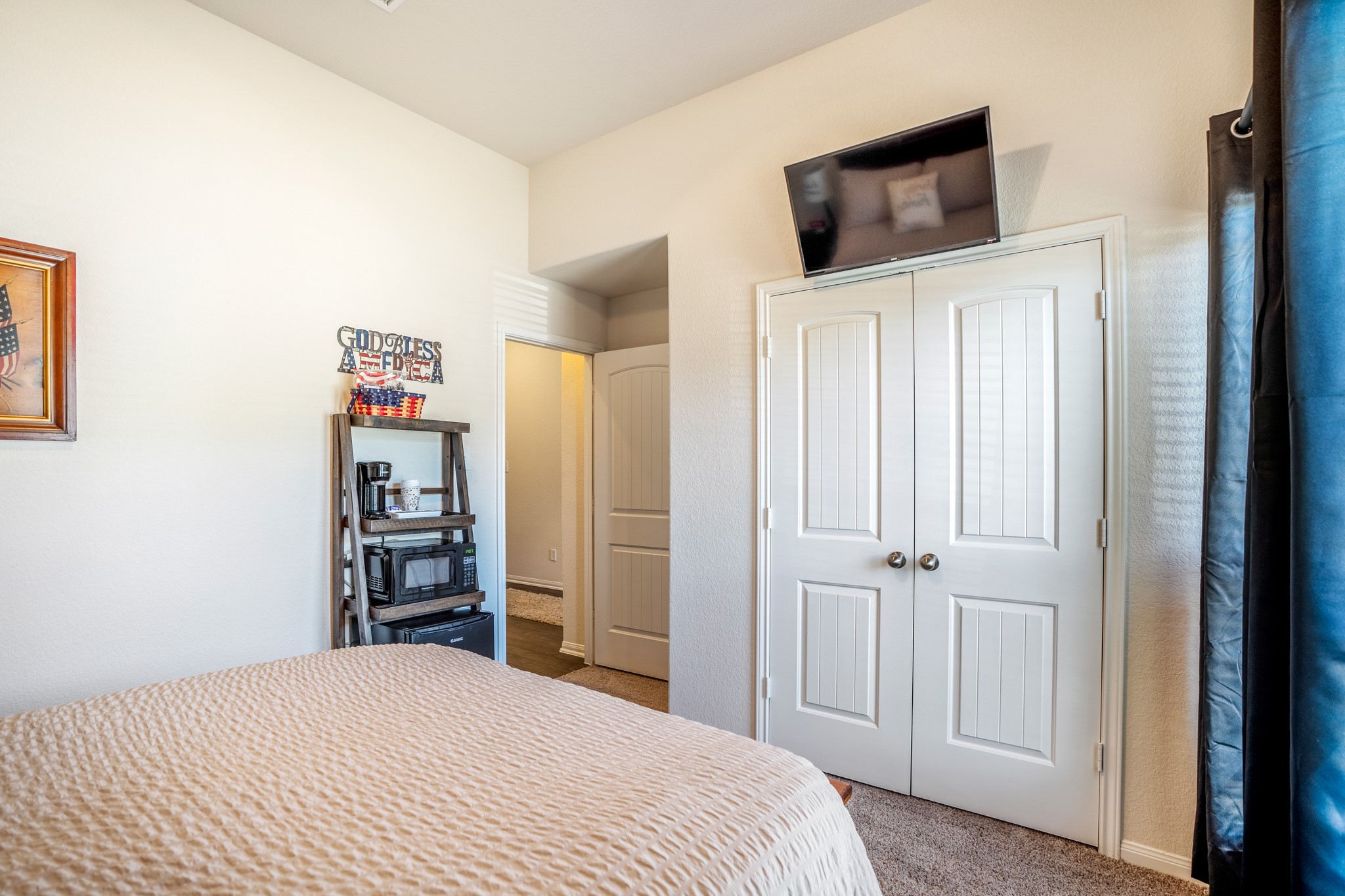 1730 Wandering Hills Road Conroe, TX 77304 - Photo 5 of 45 a bedroom with a bed and a television