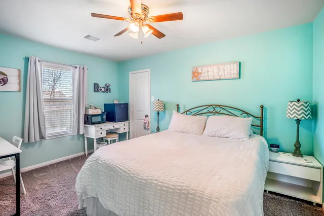 a bedroom with a bed and a table