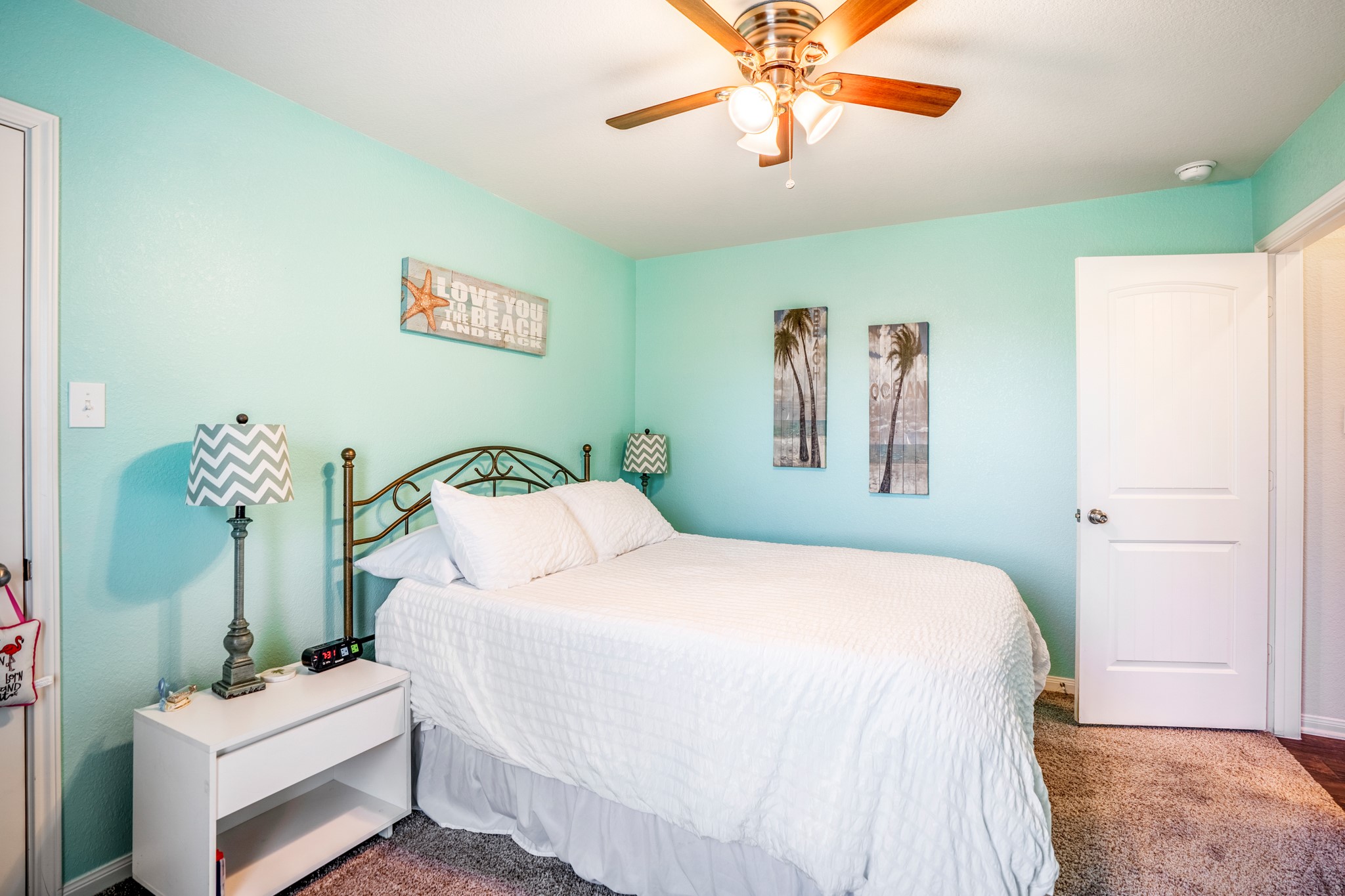 1730 Wandering Hills Road Conroe, TX 77304 - Photo 7 of 45 a bedroom with a bed and a chandelier