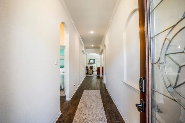a view of a hallway with a livingroom and furniture