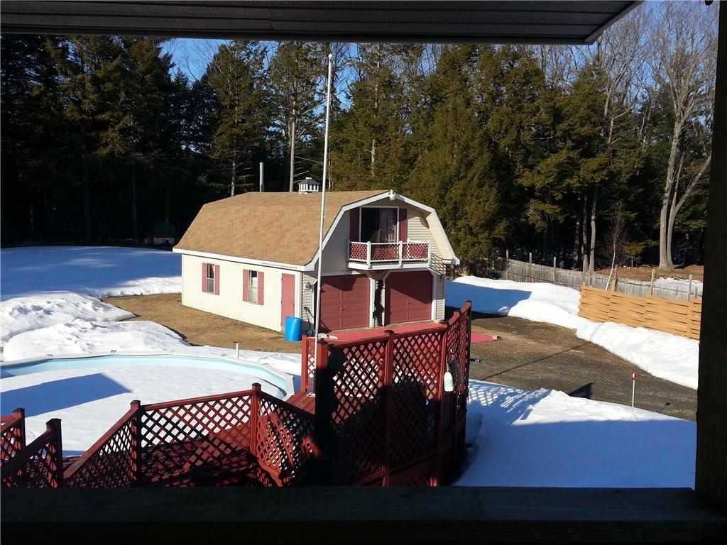 107 Dinsmore Road Sidney, ME 04330 - Photo 18 of 25 VIEW OF POOL AND GARAGE FROM DECK