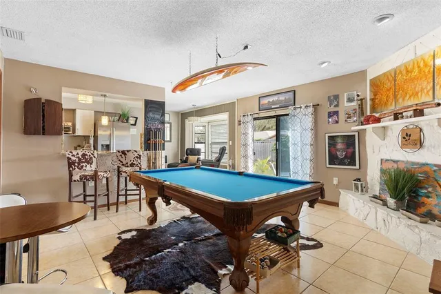 a room with furniture pool table and flat screen tv
