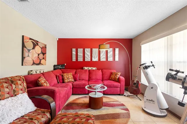 a living room with furniture and a painting