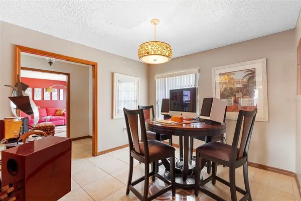 a view of a dining room with furniture and a chandelier