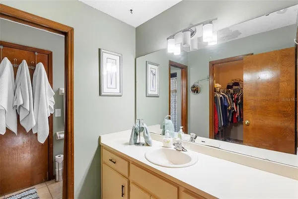 a bathroom with a sink a mirror and a shower