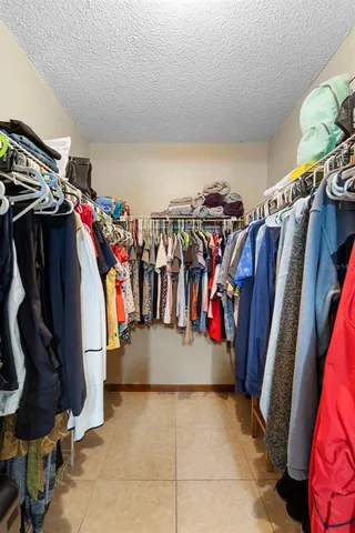 a view of walk in closet with clothes