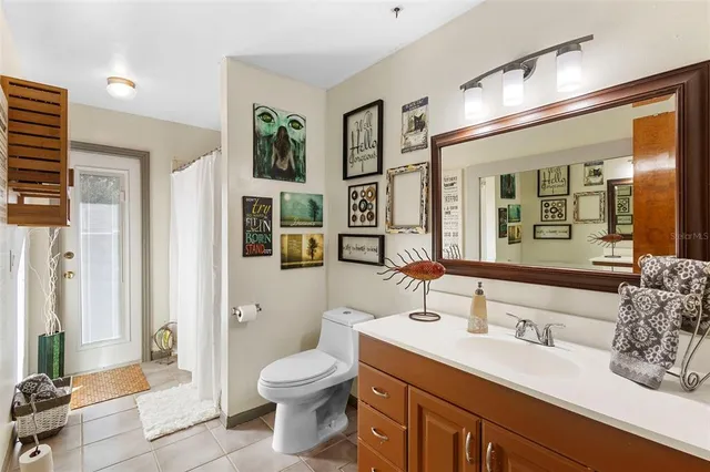 a spacious bathroom with a granite countertop sink mirror and toilet