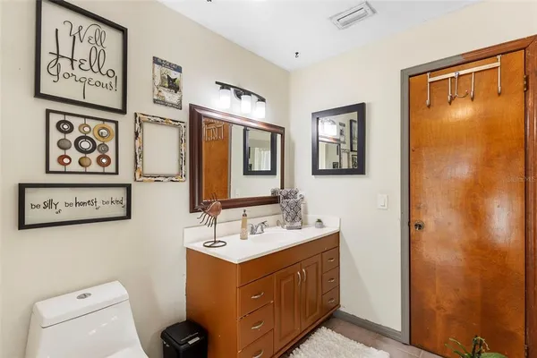 a bathroom with a sink a mirror and a toilet