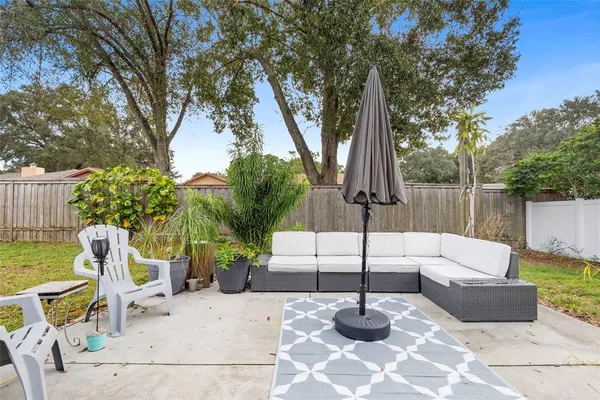 a view of a backyard with couches and a fire pit