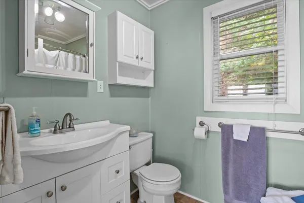 a bathroom with a sink toilet and a mirror