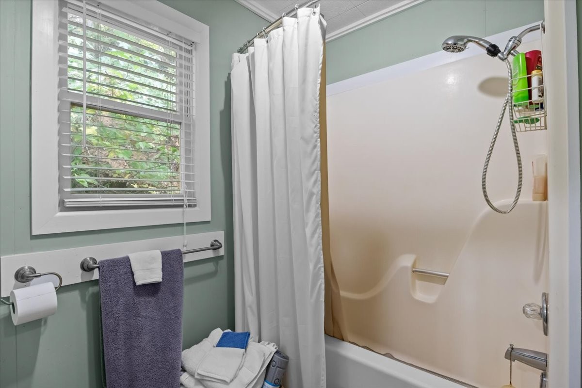 38 Lakeland Road Waverly, TN 37185 - Photo 18 of 41 a bathroom with a shower curtain and a window