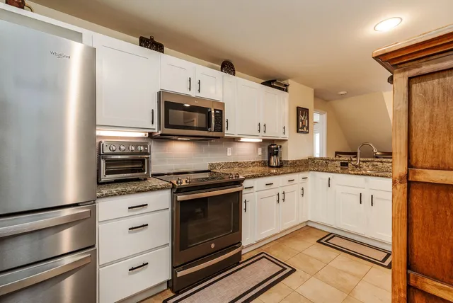 a view of a livingroom with furniture and staircase