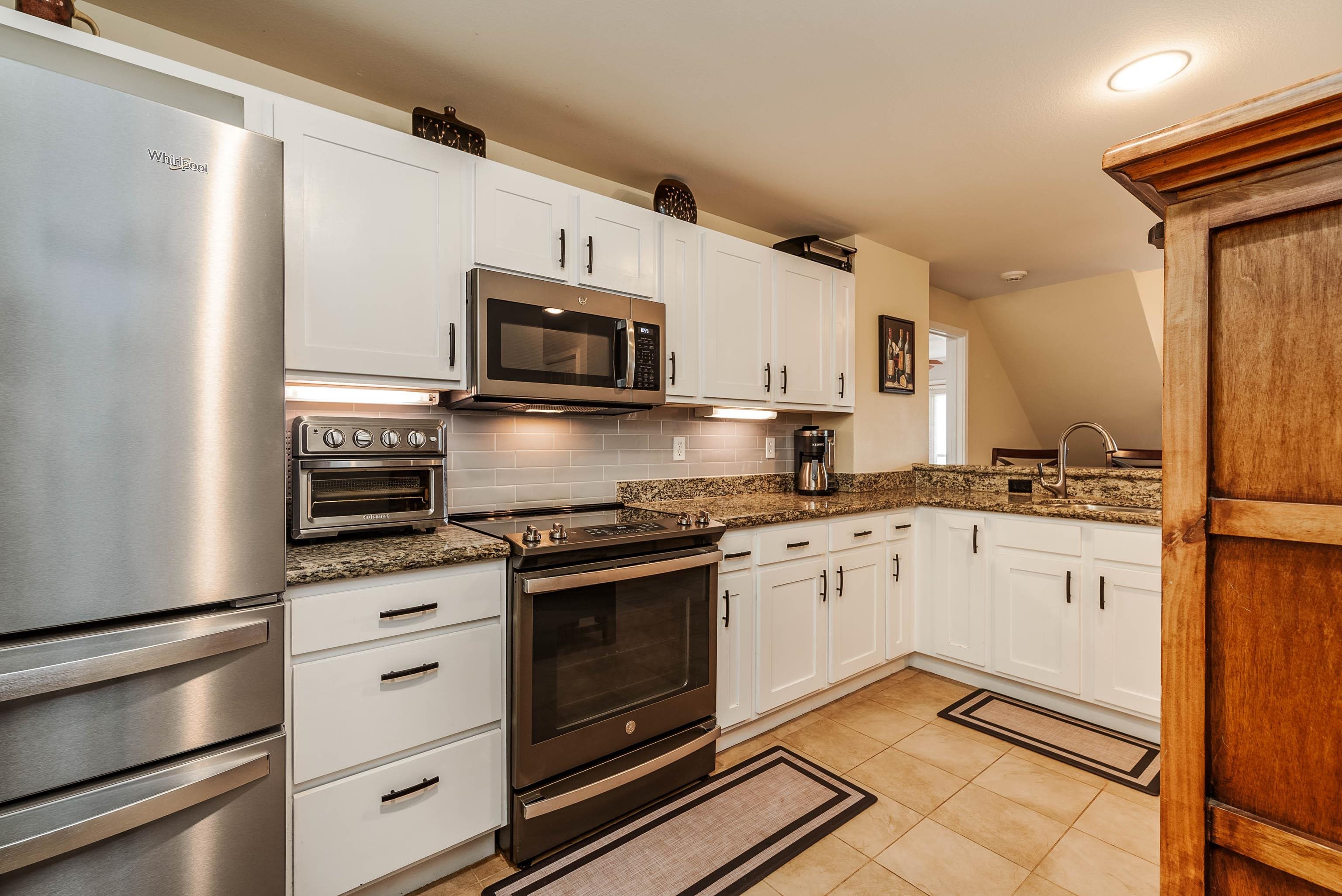 3708 Lower Honoapiilani Road, Unit E43 Lahaina, HI 96761 - Photo 12 of 40 a kitchen with granite countertop cabinets stainless steel appliances and a counter space