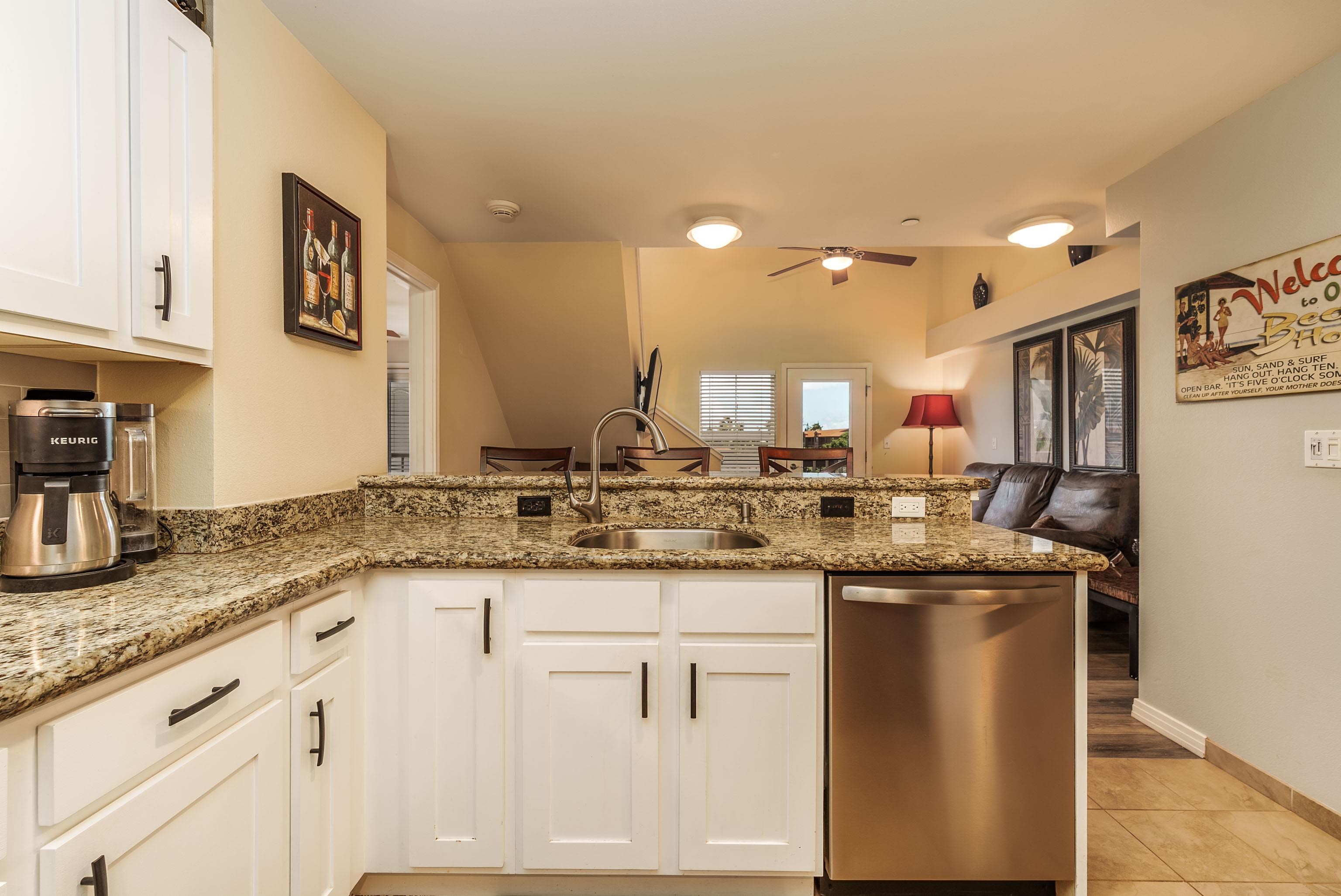 3708 Lower Honoapiilani Road, Unit E43 Lahaina, HI 96761 - Photo 13 of 40 a kitchen with granite countertop a sink and cabinets