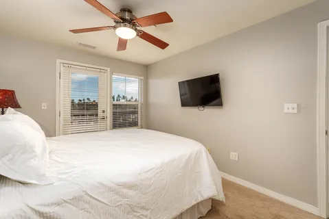 a bedroom with a bed and a flat screen tv