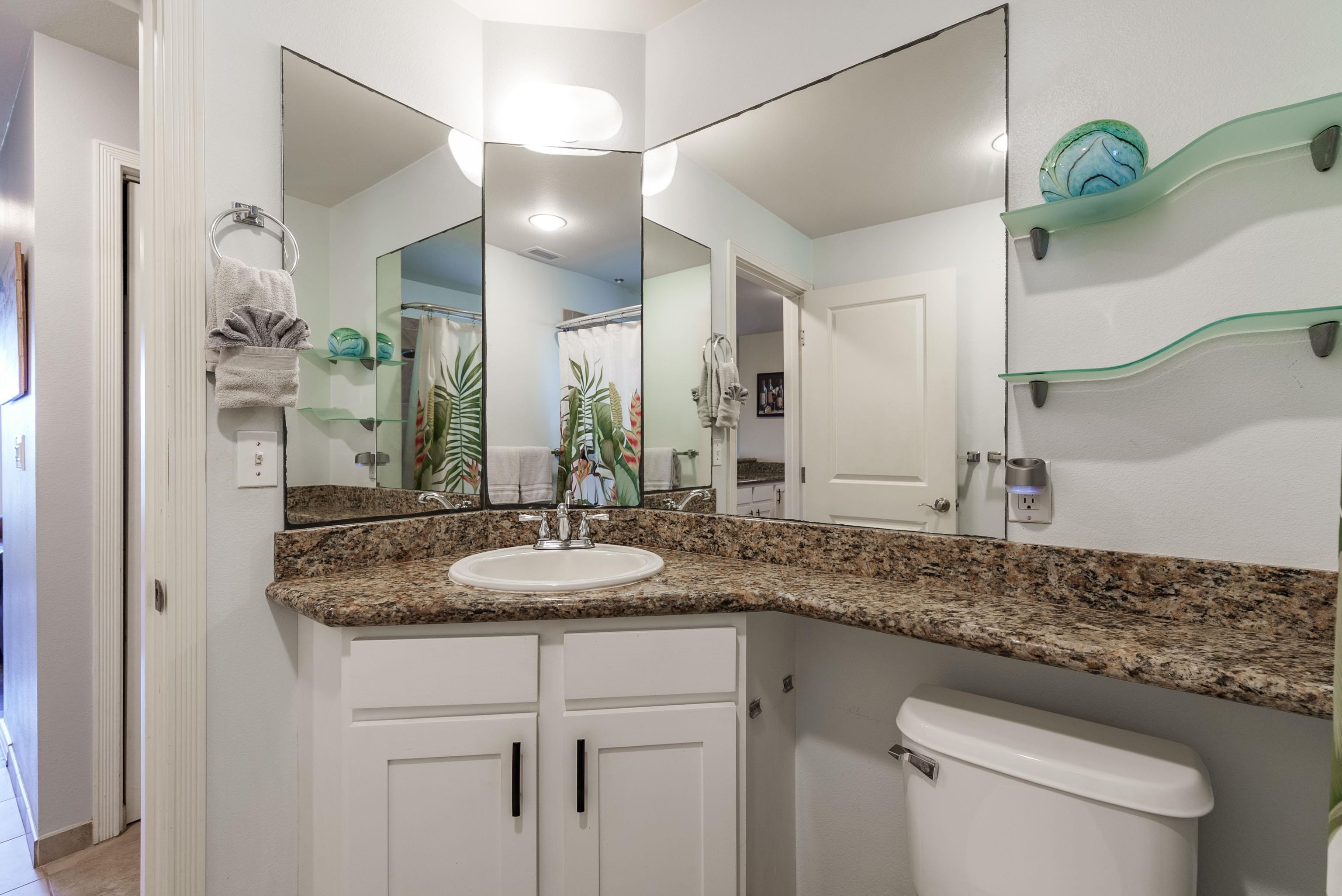 3708 Lower Honoapiilani Road, Unit E43 Lahaina, HI 96761 - Photo 20 of 40 a bathroom with a granite countertop sink a toilet and a mirror