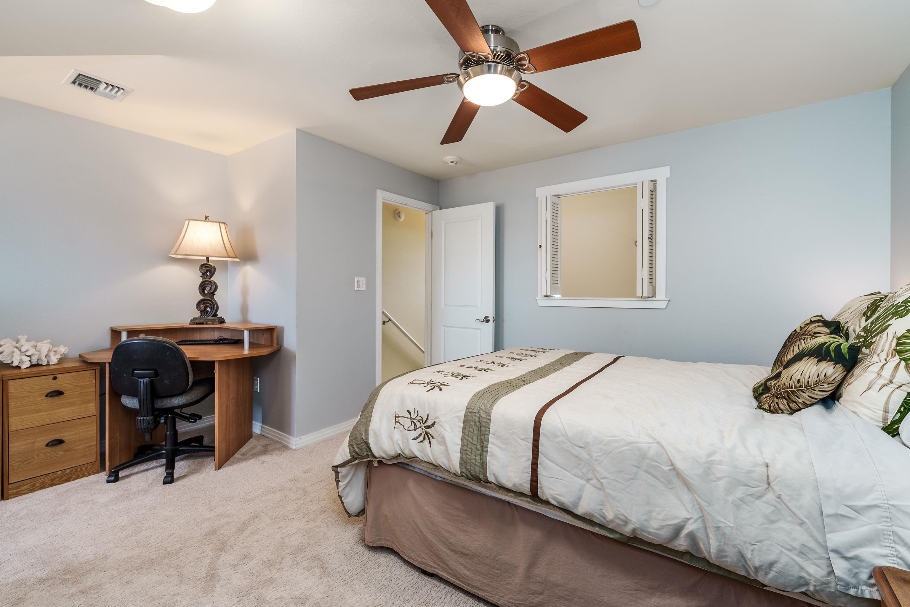 3708 Lower Honoapiilani Road, Unit E43 Lahaina, HI 96761 - Photo 25 of 40 a bedroom with a bed and a chandelier