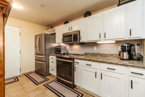 a front view of a house with swimming pool having outdoor seating