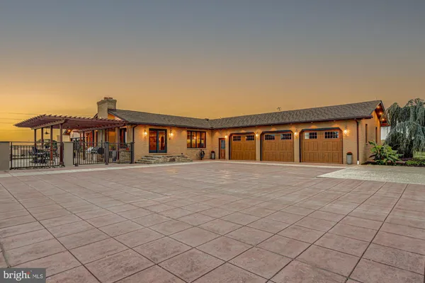 an aerial view of a house with a garden and trees