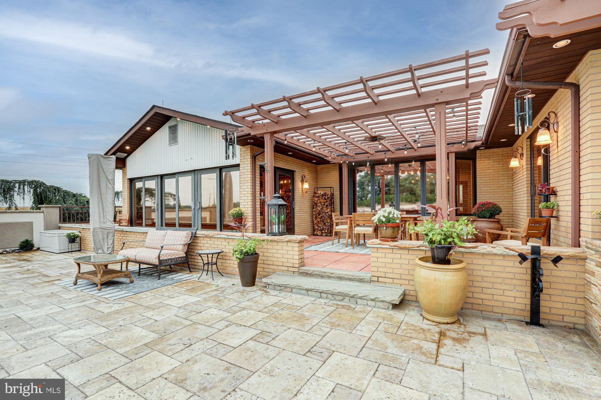 550 Green Giant Road Townsend, DE 19734 - Photo 34 of 145 a view of a patio with dining table and chairs and potted plants